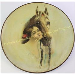 Early tin charger with great artwork of girl and horse, unmarked, 16" diameter.  Est. 75-175