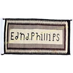 Navajo rug 25" X 26" woven with Edna Phillips in the center.  Est. 150-250