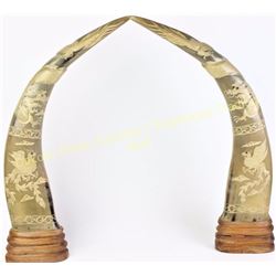 Finely carved pair horns on wood base with phoenix and dragon motif, 23" tall.  Est. 200-400