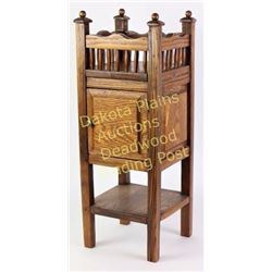 Antique oak stand with upper spindle gallery, single door and lower shelf, nice original finish, 25"