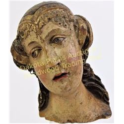 Early carved wood head of a female polychromed, 8" tall.  Est. 200-400