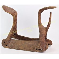 Early Northern Plains Crow Indian saddle covered in rawhide and sinew sewn, 17" at tallest and 24" l