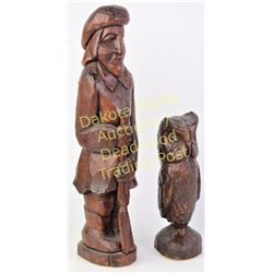 Two vintage South Dakota wood carvings bottoms with paper tags marked Eng's Studio Hill City "The Bu