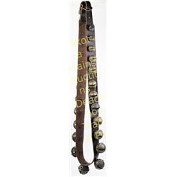 Large set brass sleigh bells 25 total in graduated sizes on leather, 64" long.  Est. 150-250