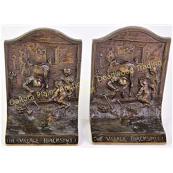 Arts and Crafts period bookends in solid copper "The Village Blacksmith".  Est. 25-75