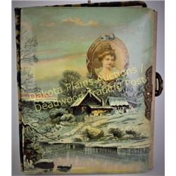 Victorian celluloid photo album with wonderful winter cabin scene front.  Est. 25-100