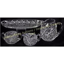 Collection of 4 American cut glass pieces includes matching creamer and sugar, water pitcher and fru
