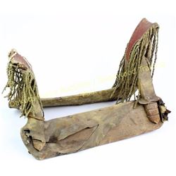 Early rawhide over wood Indian saddle 17" long, decorated twisted leather, fringe front and back, al