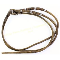 Finely braided rawhide reins with large leather popper.  Est. 75-175