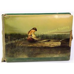 Victorian celluloid photo album depicting young girl in wooden boat.  Est. 50-100