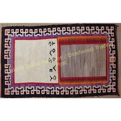 Vintage Navajo rug woven in center Casey Todac. Rug shows moderate use with some staining and small 