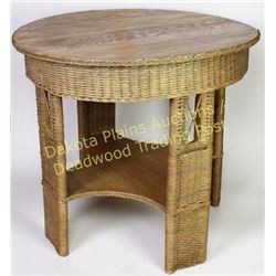 Wicker and oak round parlor table 33" round top with lower shelf.  Est. 50-100