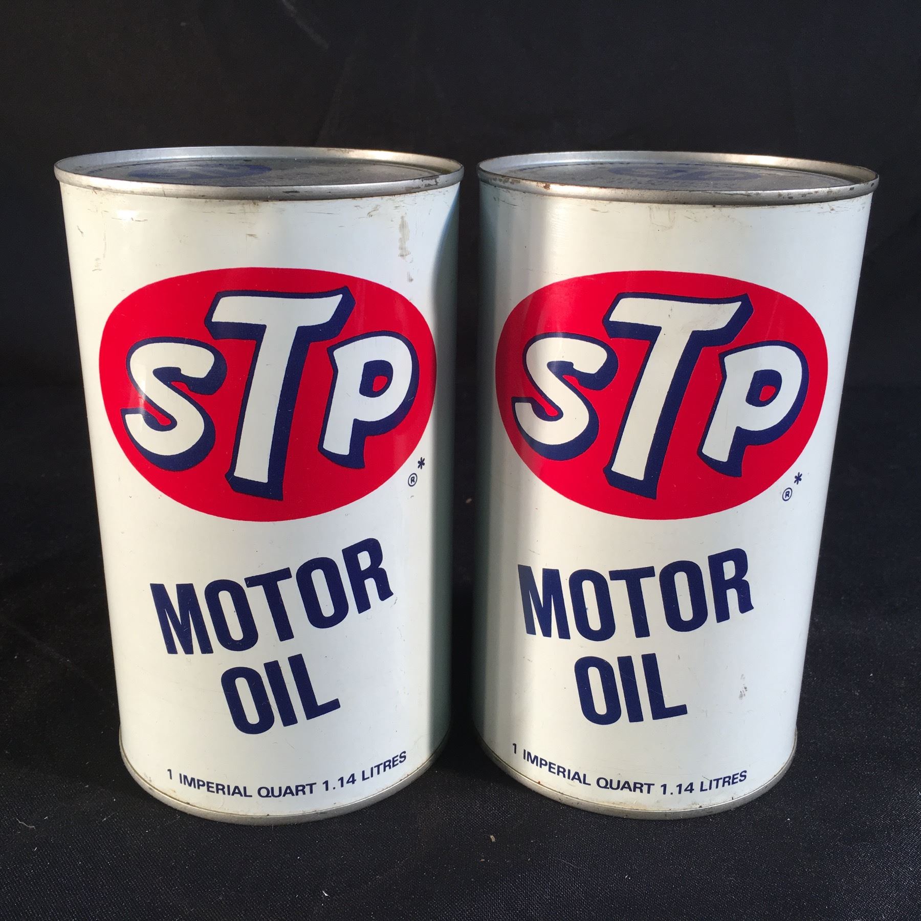 TWO STP MOTOR 1 QUART CANS, BOTH FULL AND SEALED