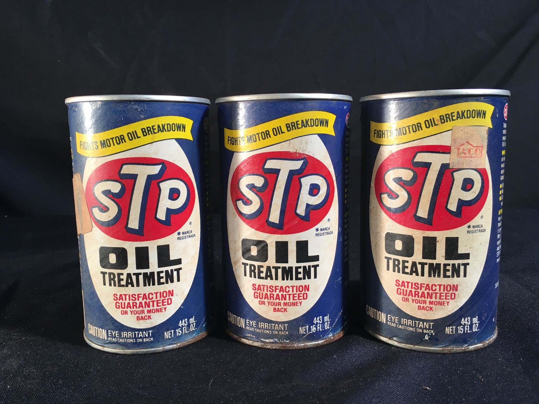 COLLECTION OF THREE VINTAGE STP OIL TREATMENT 15 FL. OZ. CANS,