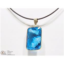 27) 14K Y. GOLD BLUE TOPAZ PENDANT W/ LEATHER CORD