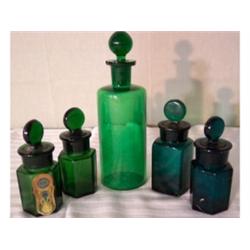 Five green glass perfume bottles