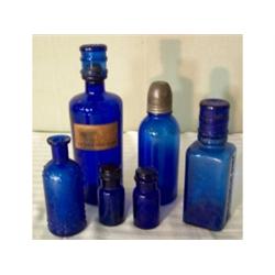 Six cobalt glass bottles