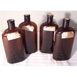 Four amber glass medicine bottles