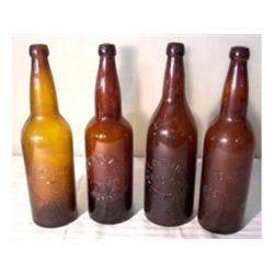 Four amber beer bottles from midwest