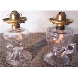 Two clear glass finger lamps
