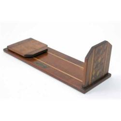 An Irish inlaid yew wood book stand, with central Tunbridge ware style panel titled ‘Killarney La...