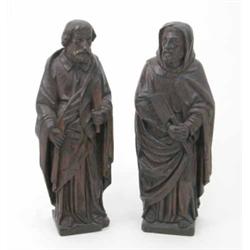 A pair of carved oak ecclesiastical figures, possibly 18th century, one holding a spear head the...