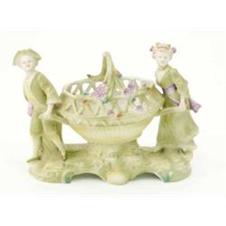 An early 20th century German porcelain group of children, in period costume carrying a basket (da...