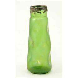 An early 20th century green iridescent glass vase, with dimpled tapered body and white metal drag...