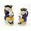Image 1 : A Victorian Toby jug, seated gentleman in blue coat holding a jug of ale, (11in.) and a matching...