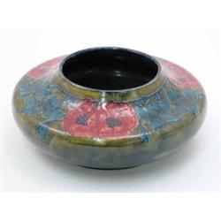 A Morris Ware bowl, of squat shouldered form decorated with raised slip flowers on blue green mot...