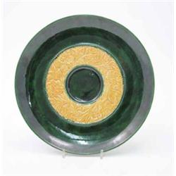 A Linthorpe Pottery plaque, impressed no. 299, the centre with a yellow circular band of raised l...