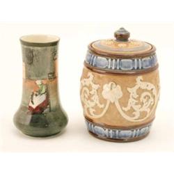 A Royal Doulton tobacco jar and vase, glazed stoneware tobacco jar relief-moulded with leaf-scrol...
