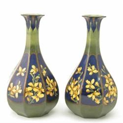 A pair of Doulton Lambeth faience octagonal baluster vases, painted with yellow blossom against b...