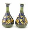 Image 1 : A pair of Doulton Lambeth faience octagonal baluster vases, painted with yellow blossom against b...
