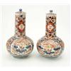 Image 1 : A pair of Imari vases and covers with cylindrical necks, bulbous bodies and flower and phoenix de...