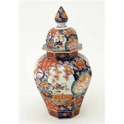 An octagonal Imari baluster vase and cover decorated with flowers in urns and phoenix. 13.5ins...