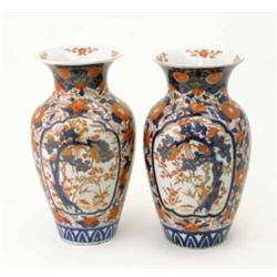A pair of Imari baluster vases, decorated with panels of birds, trees and bamboo. 12ins...