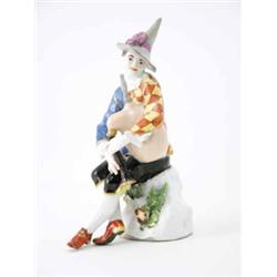 A Meissen figure of Harlequin playing the bagpipes modelled by J.J. Kaendler in conical hat with...