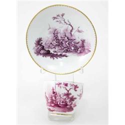 A Meissen cup and a saucer painted after Rugendas with a battle scene and martial trophies with g...