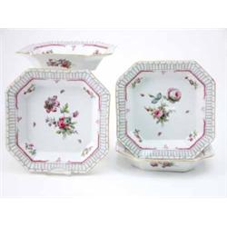 Four Berlin octagonal dishes painted with bouquets of flowers and insects within a border of scro...