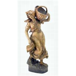 A large late 19th century Goldscheider figure, lady in flowing skirt holding wicker basket on one...