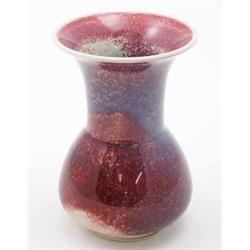 A Ruskin high fired vase, with cylindrical neck and everted rim, mottled glaze in varying shades...