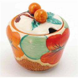 A Clarice Cliff ‘Nasturtium’ preserve pot, a bold floral design against a mottled brown ground, a...