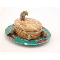 A Mintons majolica oval butter dish and cover, in the form of an oval bale of hay, the cover with...