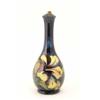Image 1 : A Moorcroft Hibiscus pattern lamp, floral pattern on dark blue ground, impressed mark, remains of...