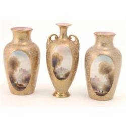 A trio of Royal Worcester vases painted by Rushton, consisting of a two-handled vase and a pair o...