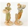 Image 1 : A pair of Royal Worcester Hadley style figures of a boy and girl, each modelled holding a basket...