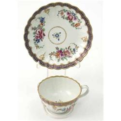 A Worcester fluted tea cup and saucer, painted with the marriage pattern of floral sprays with a...