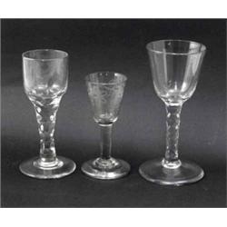Three George III drinking glasses, one with round funnel bowl and faceted stem (6.25in.), another...