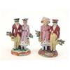 Image 1 : A pair of Victorian Staffordshire Dandy groups, each a couple, standing arm-in-arm, formally dres...